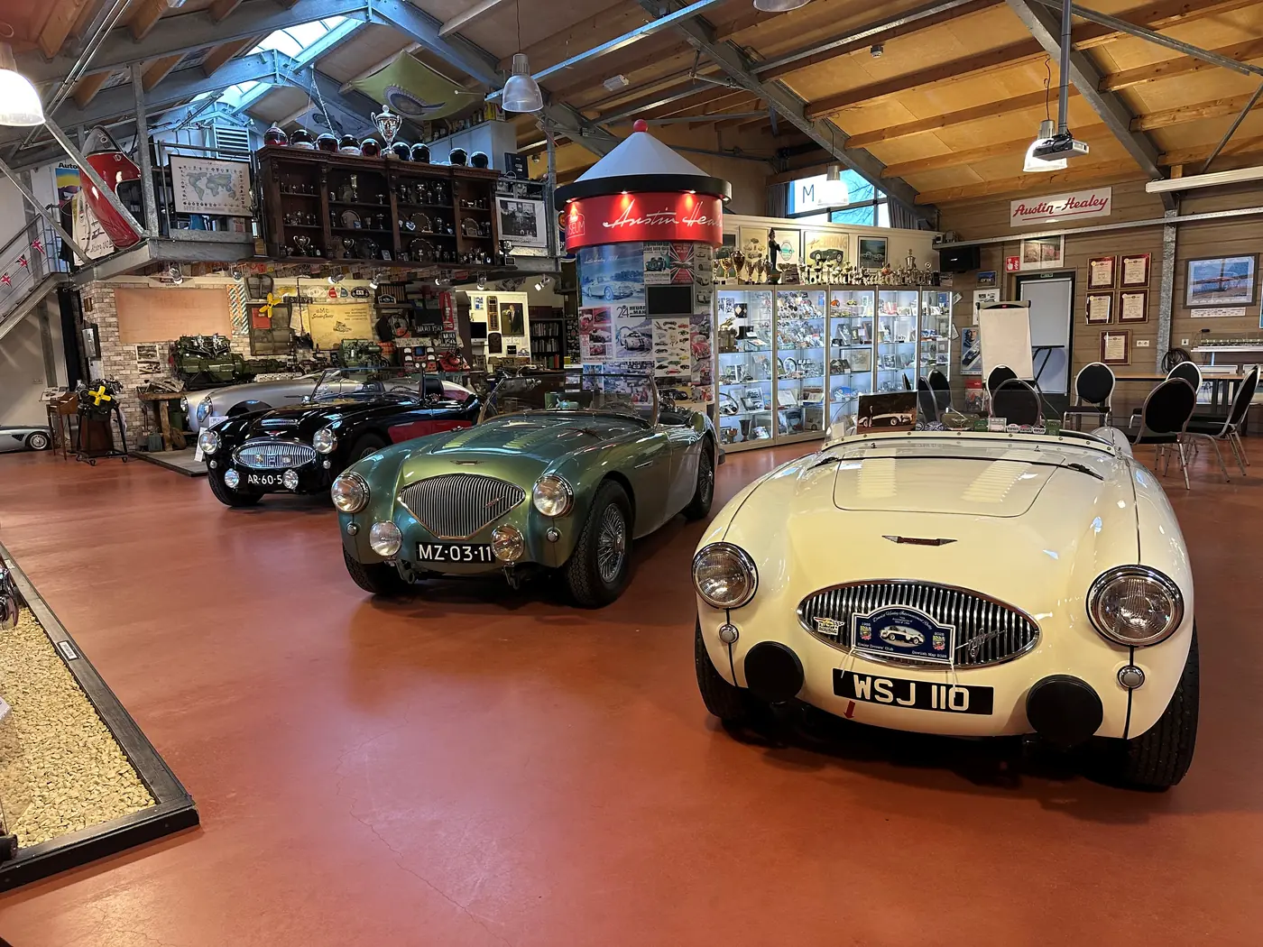 Verschillende klassieke sportauto’s in een museumzaal.