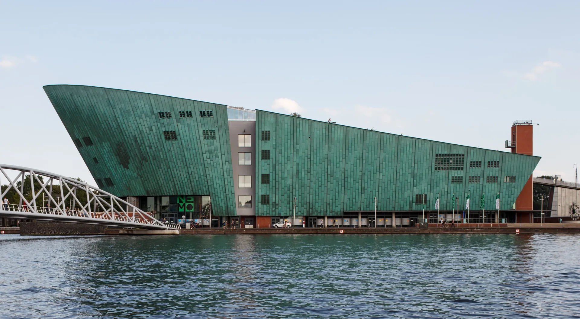 The copper-green, ship-shaped NEMO building beside the water.
