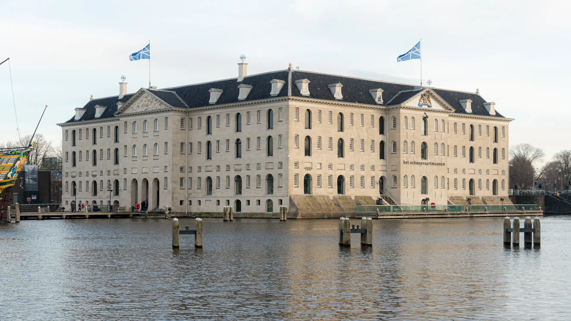 The large, light-coloured Maritime Museum building beside the water.