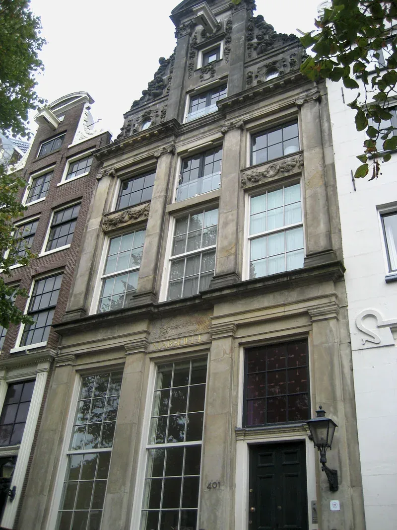 Historische gevel van Huis Marseille met hoge ramen en de naam Marseille boven de deur.